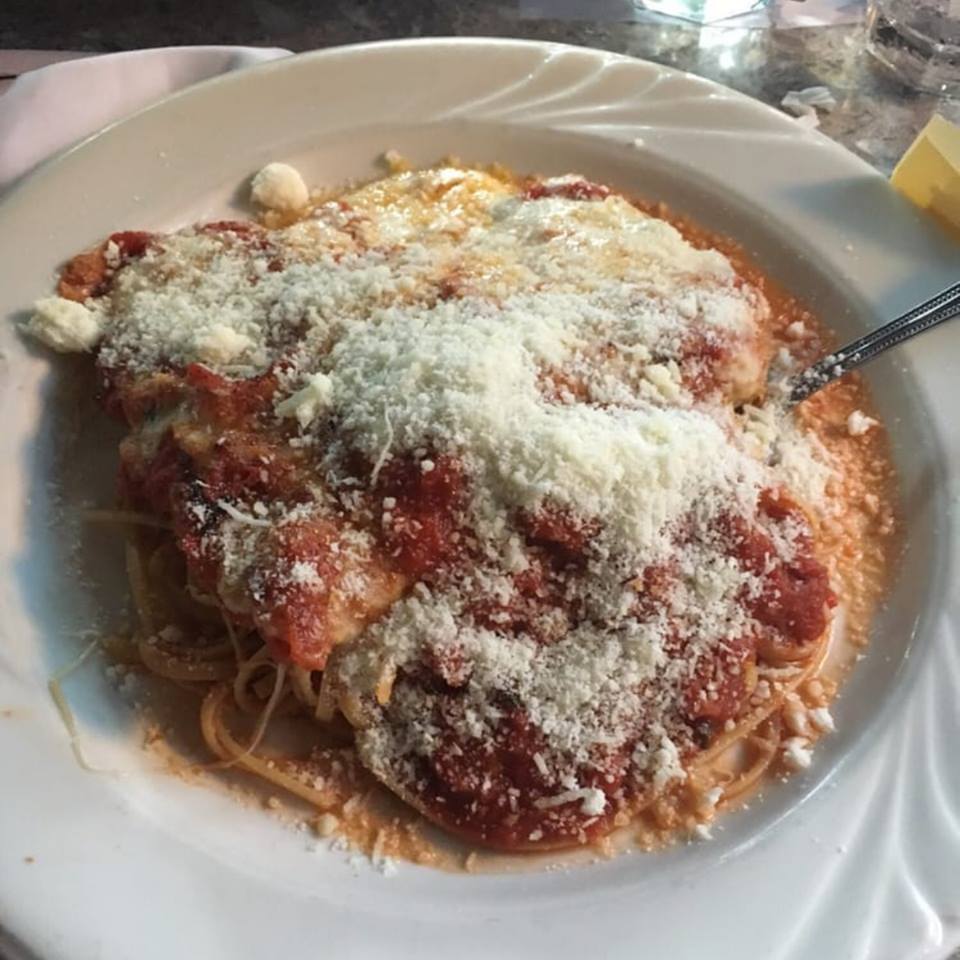 PARMIGIANA Topped with tomato sauce and mozzarella cheese served with pasta with Breaded Chicken Parmigiana